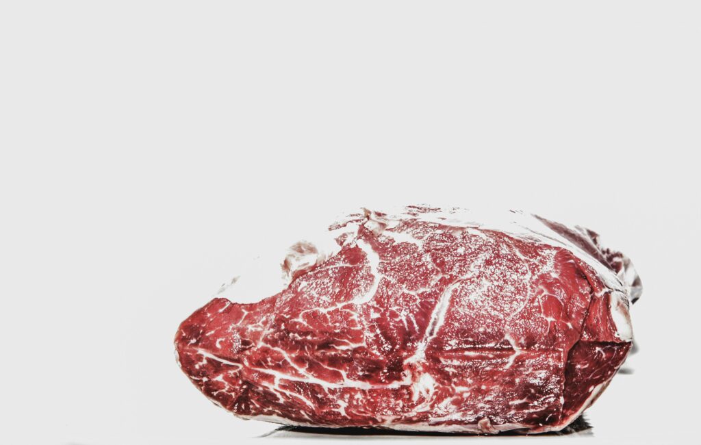 Premium raw beef piece displayed on a white background, perfect for culinary projects.